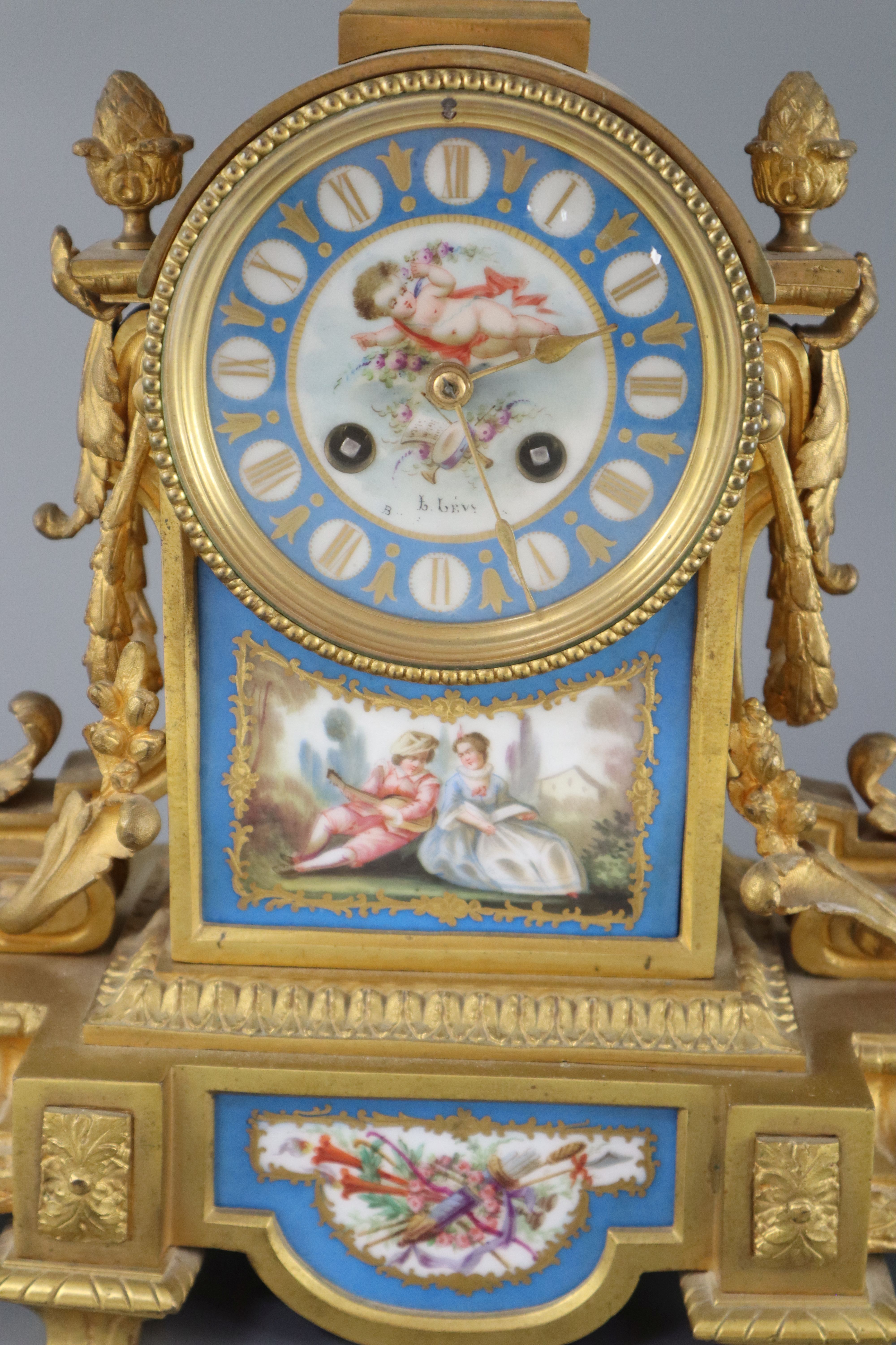 A 19th century Louis XVI style ormolu and Sevres style porcelain clock garniture, height 16.5in.